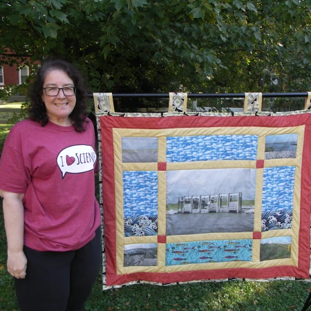 Dr. G posed with levee quilt
