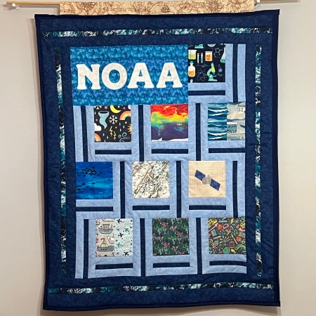 NOAA quilt hanging on wall